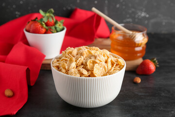 Bowl with cornflakes on black grunge background