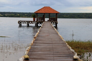 Landscape on the calm bank of a large river with a wooden dock