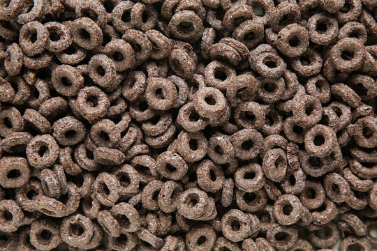 Tasty chocolate cereal rings as background, closeup