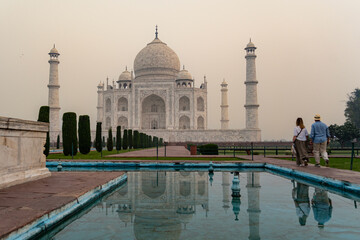 India. Uttar Pradesh state. Agra. Taj Mahal. A couple of tourists visit The Taj Mahal at sunrise