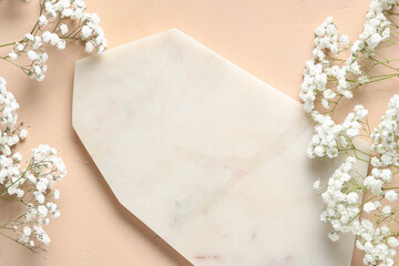 Beautiful gypsophila flowers and marble tray on beige background