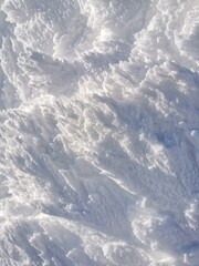 Vertical winter background with snow-covered mountain surface showcasing intricate patterns and textures