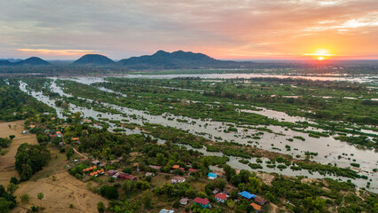 Aerial sunset landscape in Mekong River, Laos 4000 Islands, reflection in traditional tropical Village