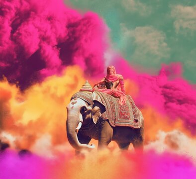 Man sitting on an elephant, mahoot, surrounded colorful powder smoke, Happy Holi concept