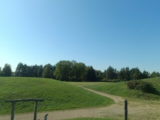 Salduve hill during sunny day. Small hill. Grass is growing on hill. Staircase leading to the top....