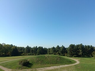 Salduve hill during sunny day. Small hill. Grass is growing on hill. Staircase leading to the top....