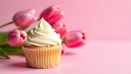 Sweet cupcake and tulip flowers on pink background. Text space, celebration concept