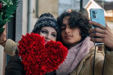 young couple taking a selfie or live video on valentine's day