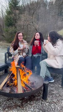 Warm moments shared around a crackling fire in the woods with friends on a chilly day