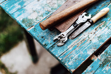 vintage old repair tools, old hammer, wrenches, men's repair tools on a blue wooden table