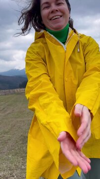 Joyful exploration in the mountains on a cloudy day wearing a bright yellow jacket