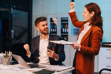 Smiling happy business team feel work complete, success at work in the office concept, employees working overtime.