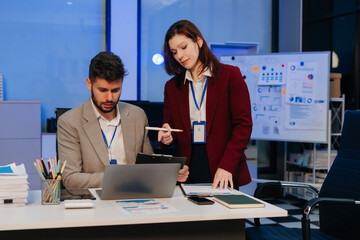 Diversity, business team working at office with laptop and documents on desk, financial adviser analyzing data, employees working overtime.