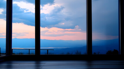 Mountain sunset view from large window in modern home