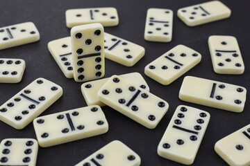 pile of white domino stones dark background