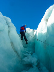 Male climber descends into crevasse, Franz Josef Glacier, Westland Tai Poutini National Park, South...