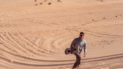 man sandboarding colored canyon in the Sinai desert in Egypt