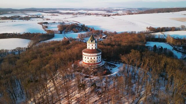 Beautiful Humprecht chateau in the winter. Baroque building in the middle of the forest, surrounded by snow covered fields of Bohemian Paradise.