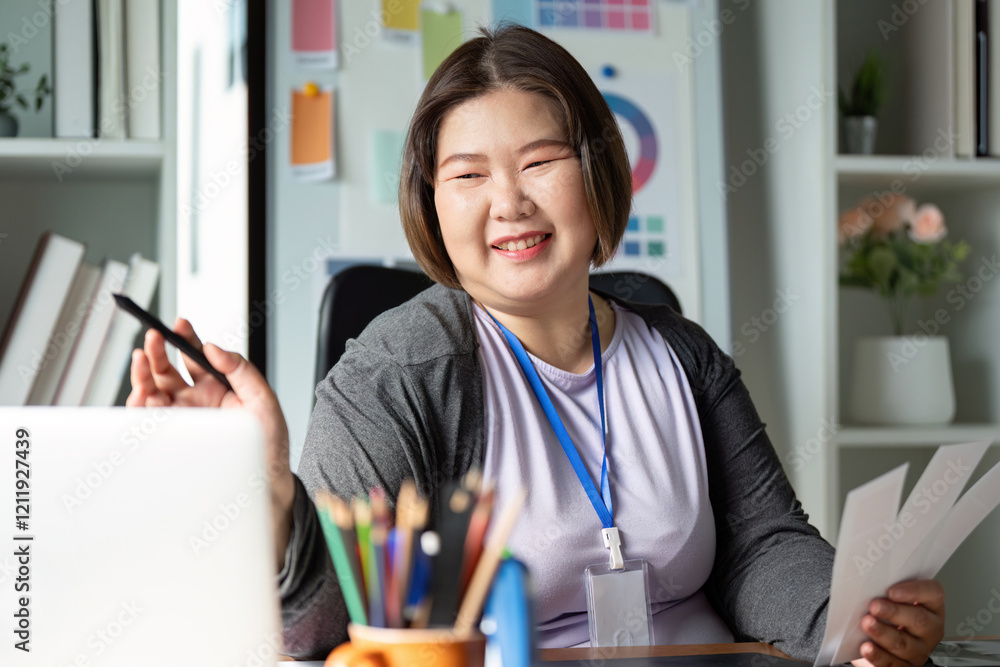 Poster smiling graphic designer presenting design ideas in a creative workspace with color samples and tool