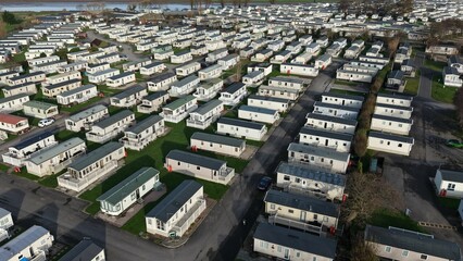 Aerial view of a large caravan park with rows of mobile homes set in a rural landscape