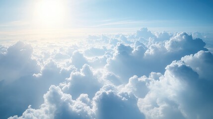 Dreamy aerial view of soft white clouds illuminated by sunlight against a bright blue sky conveying a sense of freedom and serenity.