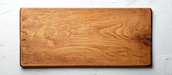 Obraz premium Top view of smooth brown wooden cutting board on bright white background with ample negative space for text and design elements