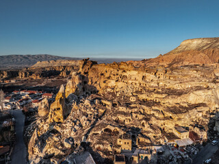 Aerial view of Çavuşin Kalesi, a fortress riddled with caves, at sunset