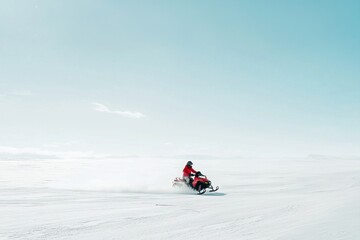 Snowmobiler Speeding Across an Open Snowy Plain on a Clear Day