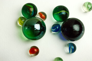 Colourful blue and green glass balls isolated on white background top view. Marble toys. Congkak is a traditional game in Asia. Marbles wallpapers.
