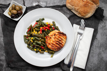 gried chicken burger with boiled green beans on plate