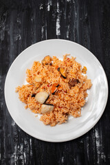 rice with seafood in white dish