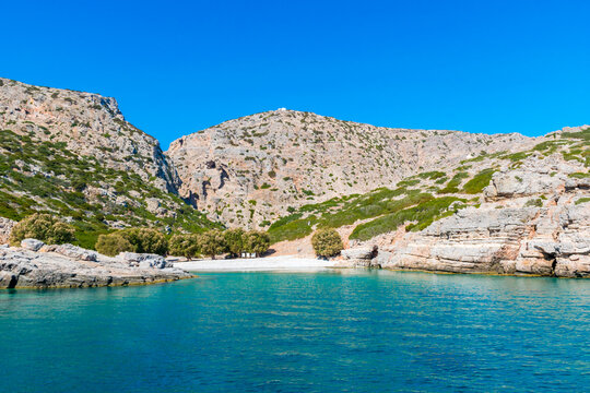 Palatia, Turquoise beach on Saria Island with white chapel above, Karpathos Island, Greece