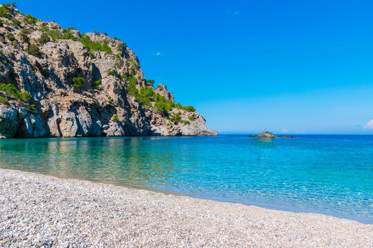 Emerald-green sea of pebbled Achata beach on Karpathos island, Greece