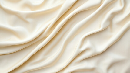 Obraz premium Soft cream fabric draped elegantly, showcasing smooth texture and folds