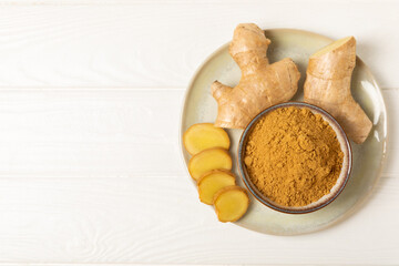 Fresh ginger on wooden background. Dry ginger. Sliced ​​ginger with honey and lemon. Ginger root. Traditional alternative medicine, healing tea for immunity. Seasoning and spices concept. Copy space.