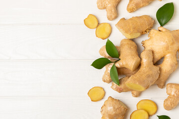 Fresh ginger on wooden background. Dry ginger. Sliced ​​ginger with honey and lemon. Ginger...