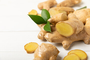 Fresh ginger on wooden background. Dry ginger. Sliced ​​ginger with honey and lemon. Ginger...