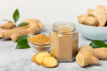 Fresh ginger on wooden background. Dry ginger. Sliced ​​ginger with honey and lemon. Ginger...