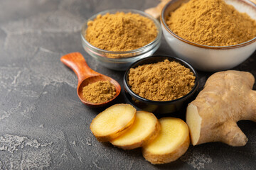 Fresh ginger on wooden background. Dry ginger. Sliced ​​ginger with honey and lemon. Ginger root. Traditional alternative medicine, healing tea for immunity. Seasoning and spices concept. Copy space.