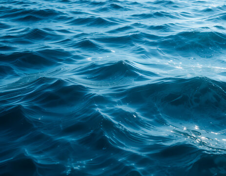 deep blue water surface with sunlight reflections, tranquil ocean waves, serene aquatic texture, close-up water photography