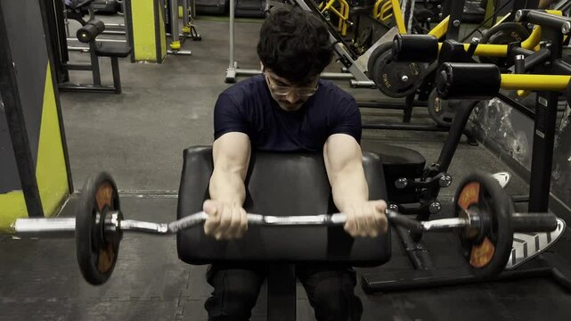 man performing EZ Bar Preacher Curl 