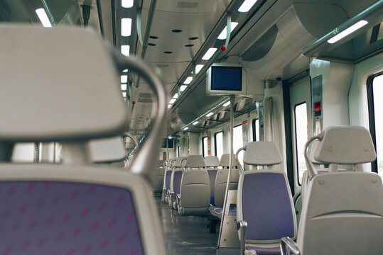Modern train interior with empty seats and ambient lighting