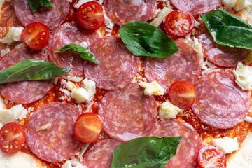 Pizza texture background with tomato sauce and cheese. Raw pizza close-up.