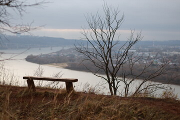 Bench is on a hill overlooking a river