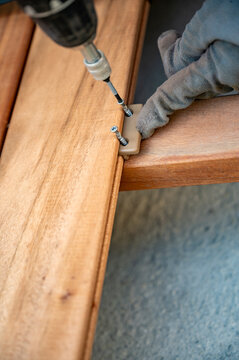 Closeup of using screws to fixate wooden plank