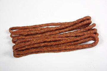 Kabanos dried sausages on white background. Polish thin, long, dry sausage