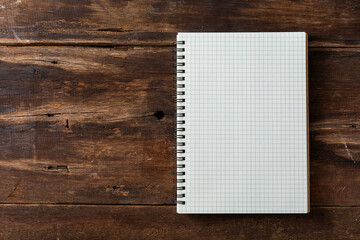 note book on wooden background