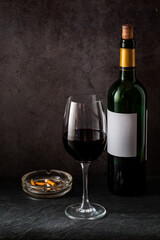 bottle and glass of red wine