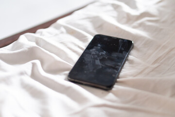 Smart phone on White Bed Sheet