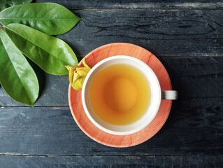 Soursop leaf boiled water in glass on wooden table with top view angle setup, Healthy drink lifestyle 